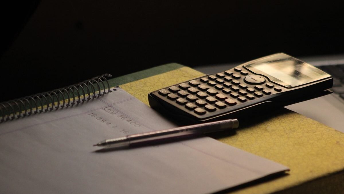 Close-up of a calculator and notebook on a study desk. Ideal for education themes
