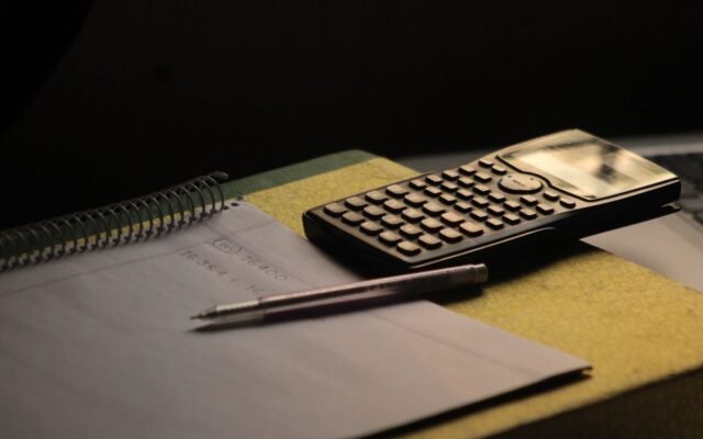 Close-up of a calculator and notebook on a study desk. Ideal for education themes
