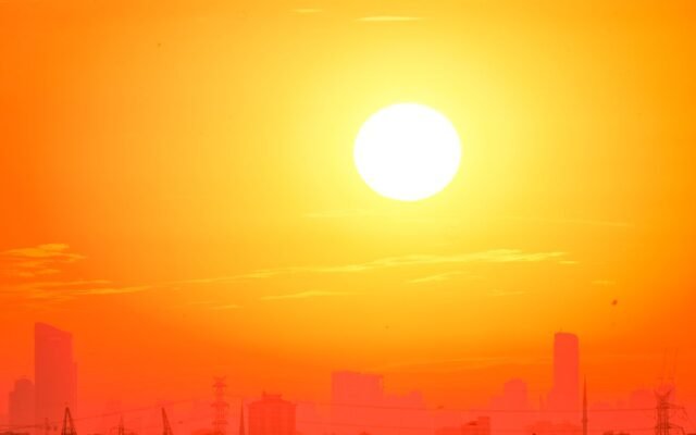 A city skyline silhouetted against a vivid
