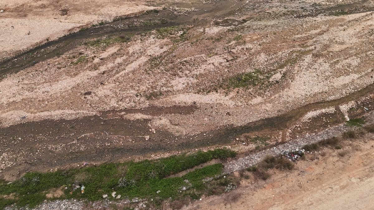 Aerial shot of a dry riverbed with rocky terrain