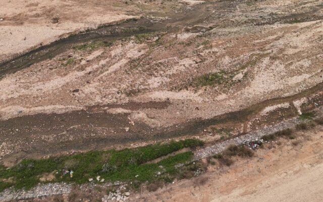 Aerial shot of a dry riverbed with rocky terrain