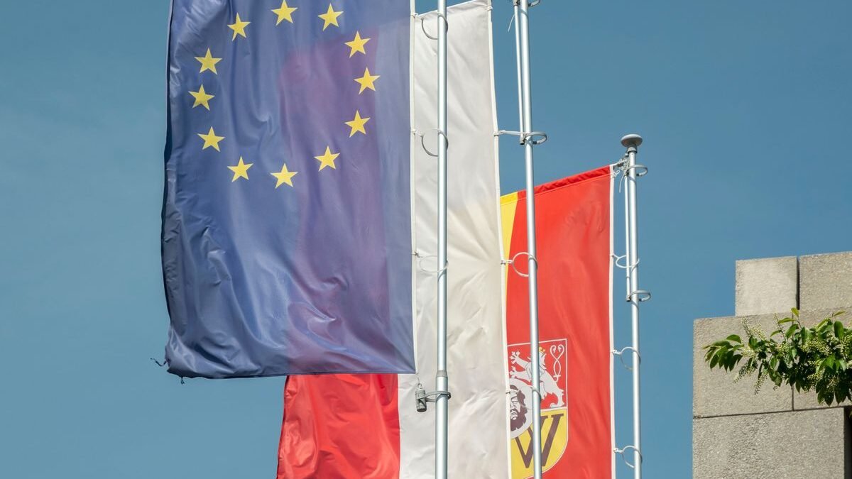 Flags of the European Union and Poland flying high in Wrocław