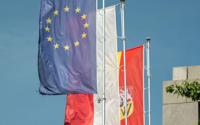 Flags of the European Union and Poland flying high in Wrocław