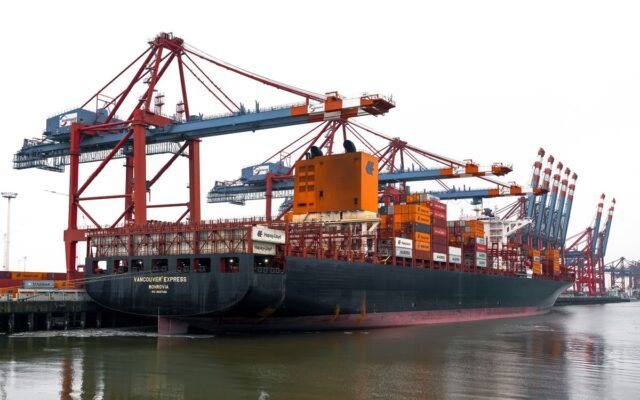 Vivid scene of container ships and cranes at the bustling Hamburg Port in Germany