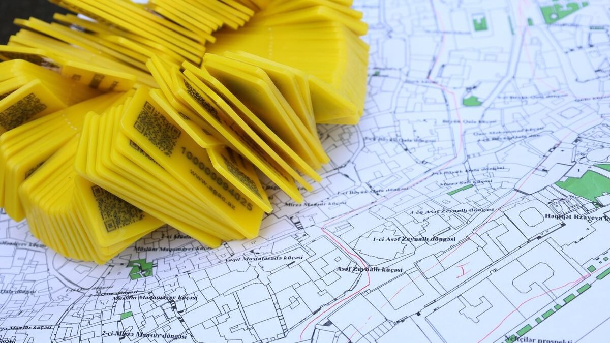 Stack of yellow QR code markers placed on a detailed map for location tracking and navigation