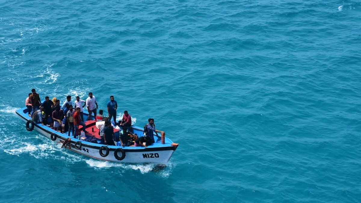 A crowded boat filled with people enjoying a ride on the vivid blue ocean waters