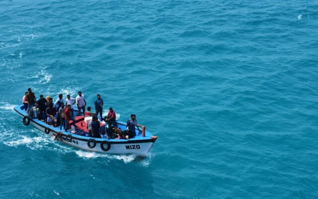 A crowded boat filled with people enjoying a ride on the vivid blue ocean waters