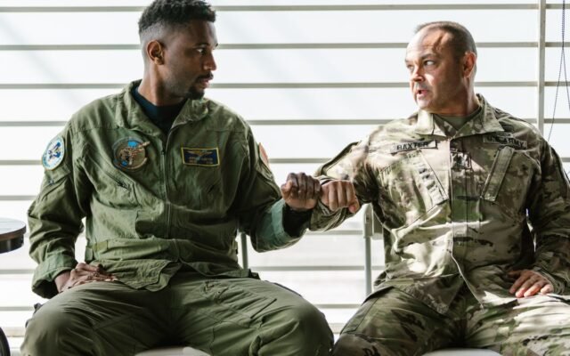 Two US military men in uniform share a fist bump