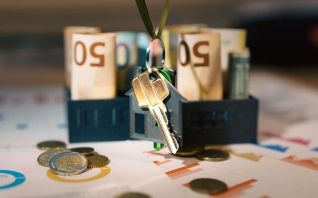 Keys hanging with money and charts