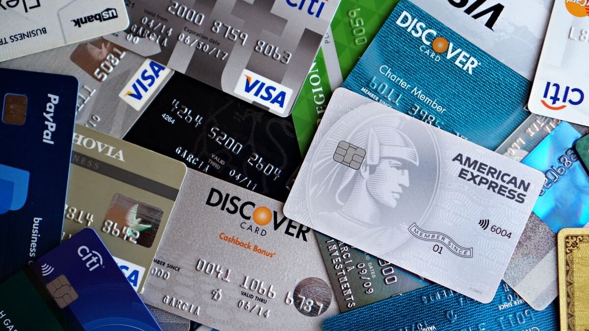 A flat lay of assorted credit and debit cards from various banks.