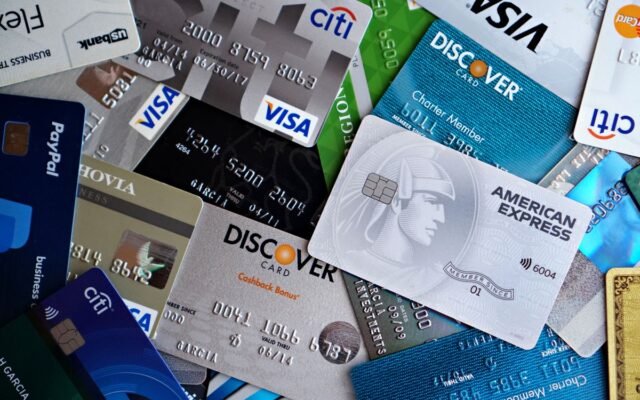 A flat lay of assorted credit and debit cards from various banks.