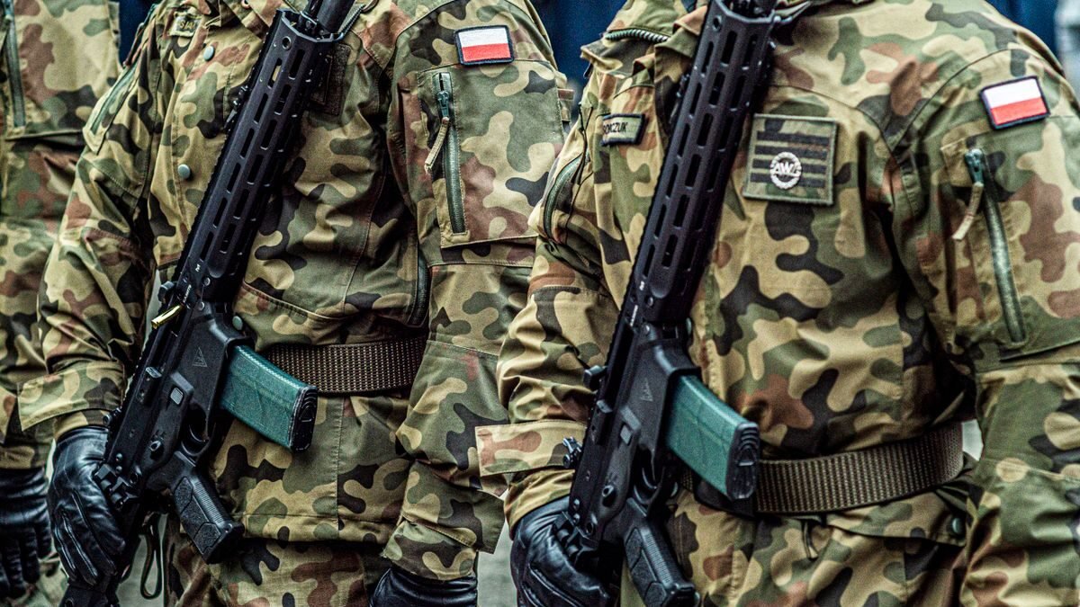 Polish soldiers in uniform standing in formation with rifles