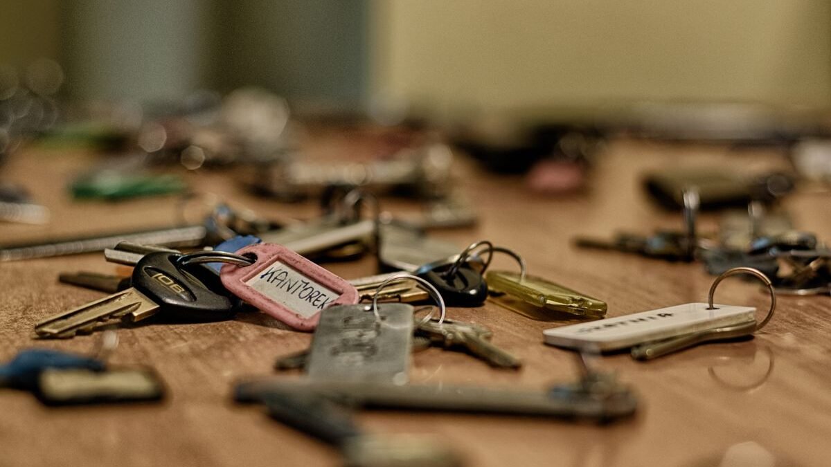 Macro shot of various metallic keys scattered on a wooden surface