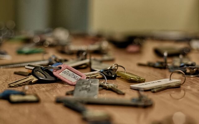 Macro shot of various metallic keys scattered on a wooden surface