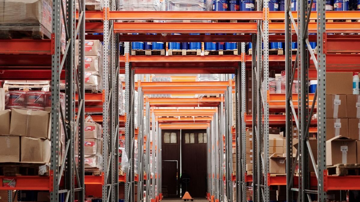 A modern warehouse interior showcasing organized shelves and pallets for efficient storage