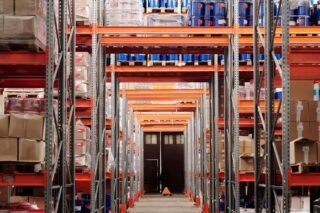 A modern warehouse interior showcasing organized shelves and pallets for efficient storage