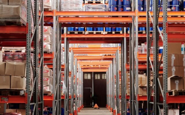 A modern warehouse interior showcasing organized shelves and pallets for efficient storage